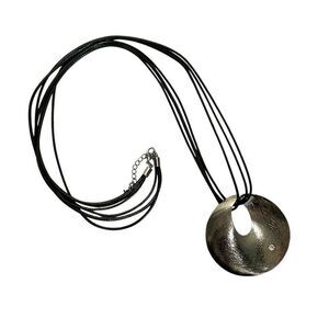 Round silver tone pendant necklace on long black cord